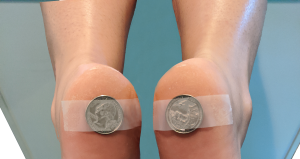 Coins taped to heels